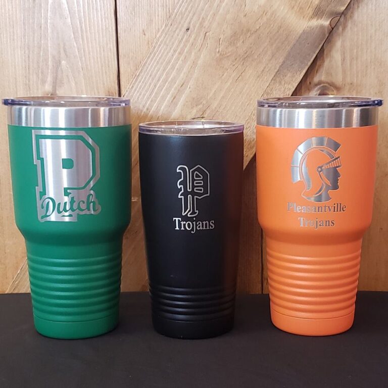Personalized Polar Cups engraved with school logos and student names using an AP Lazer machine for educational use.