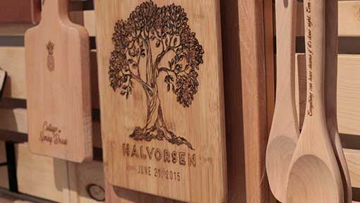 Several wooden kitchen utensils, including a cutting board with a tree design