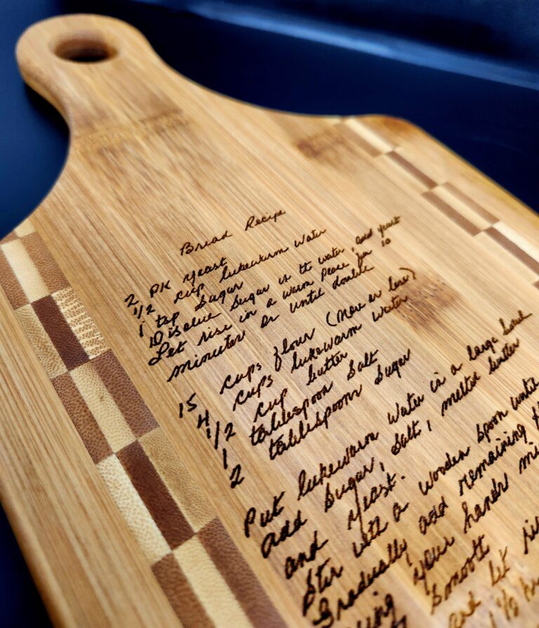 A beautifully engraved bamboo cutting board featuring a handwritten family recipe, preserving a cherished grandmother's cooking tradition with intricate laser engraving. Title: Engraved Handwritten Recipe Cutting Board – A Timeless Family Keepsake