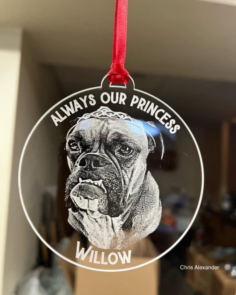 A beautifully laser-engraved and cut acrylic Christmas ornament featuring a detailed portrait of a dog named Willow, adorned with a crown and the inscription "Always Our Princess."