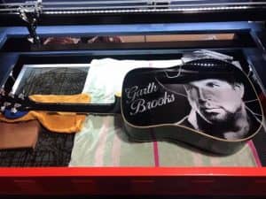 engraved guitar on laser machine with Garth Brooks name and photo